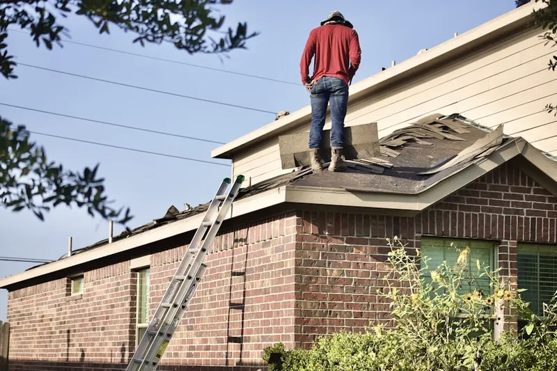 Professional roofer working on a residential roof in Lucerne Valley